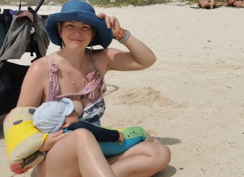 mom feeling awesome on a beach